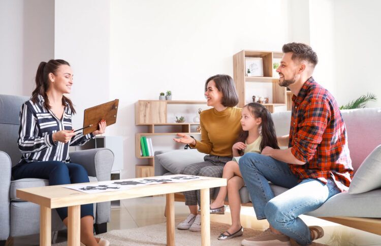 Family sitting together with a therapist during a Family Therapy session, focused on rebuilding relationships and improving communication.