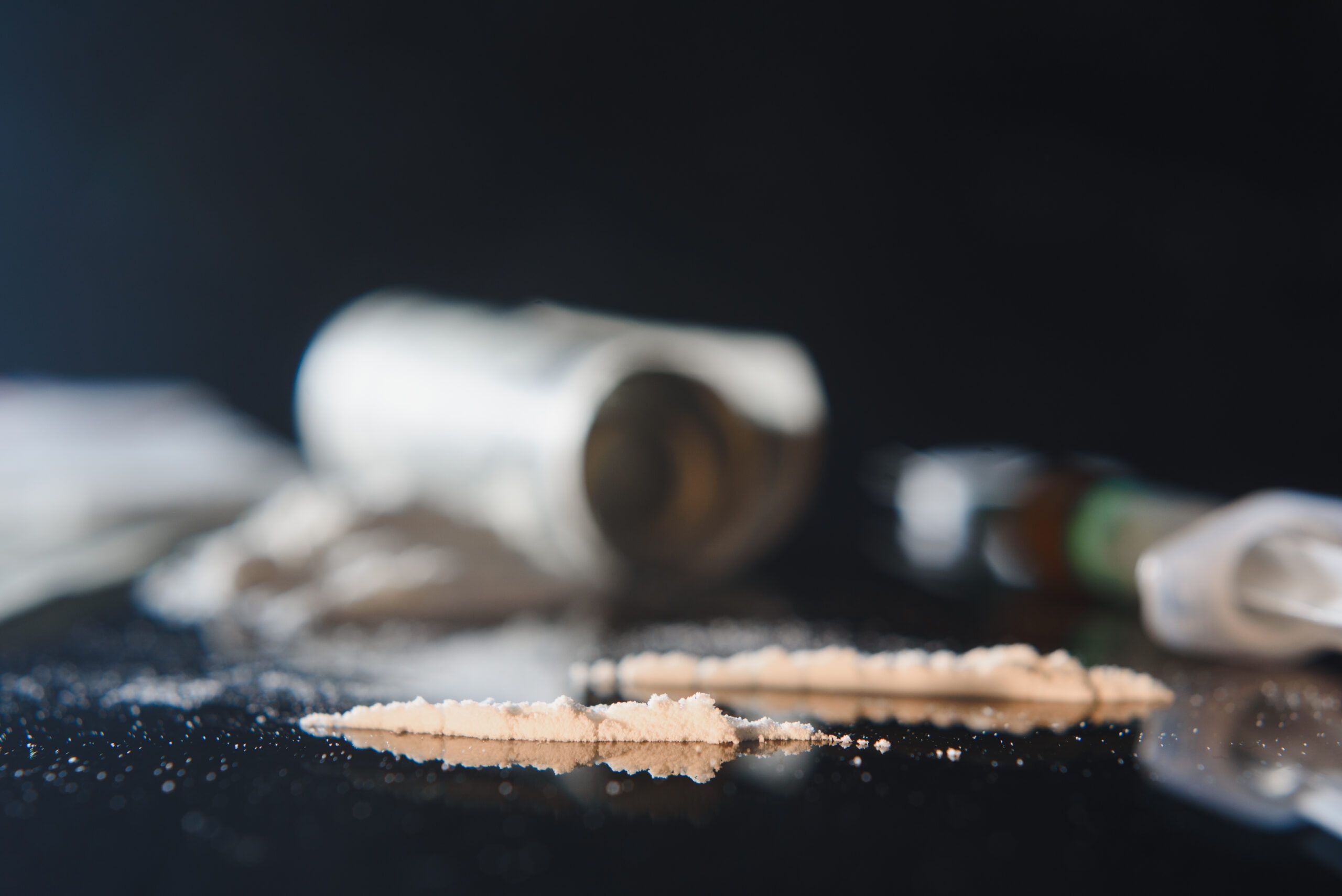 Image showing cocaine powder and rolled bills on a dark surface, representing the need for Cocaine Rehab in Nashville, TN to support recovery and treatment from addiction.