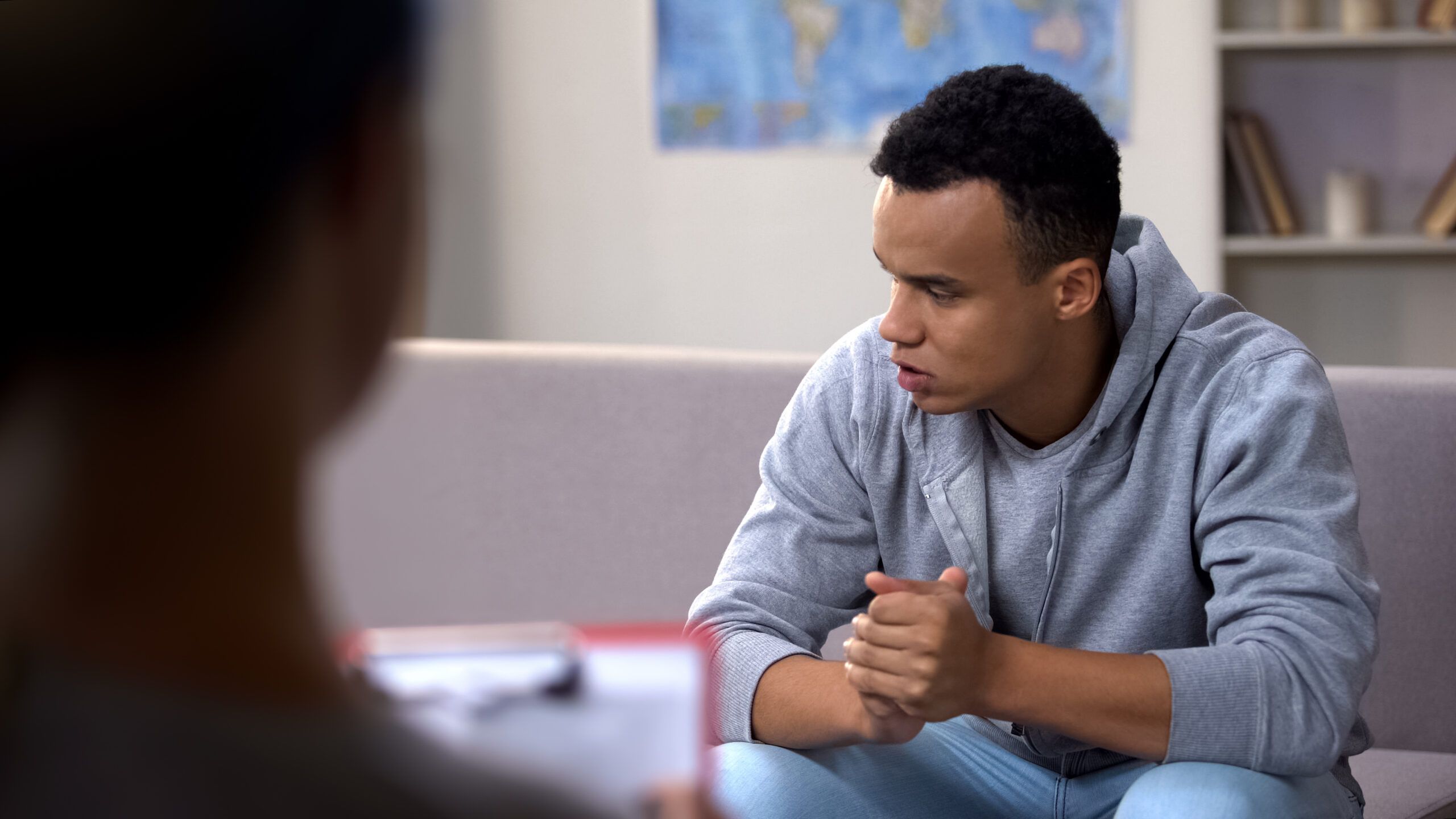 Young man in a counseling session, seeking help for addiction recovery, illustrating the process of detoxing from heroin.