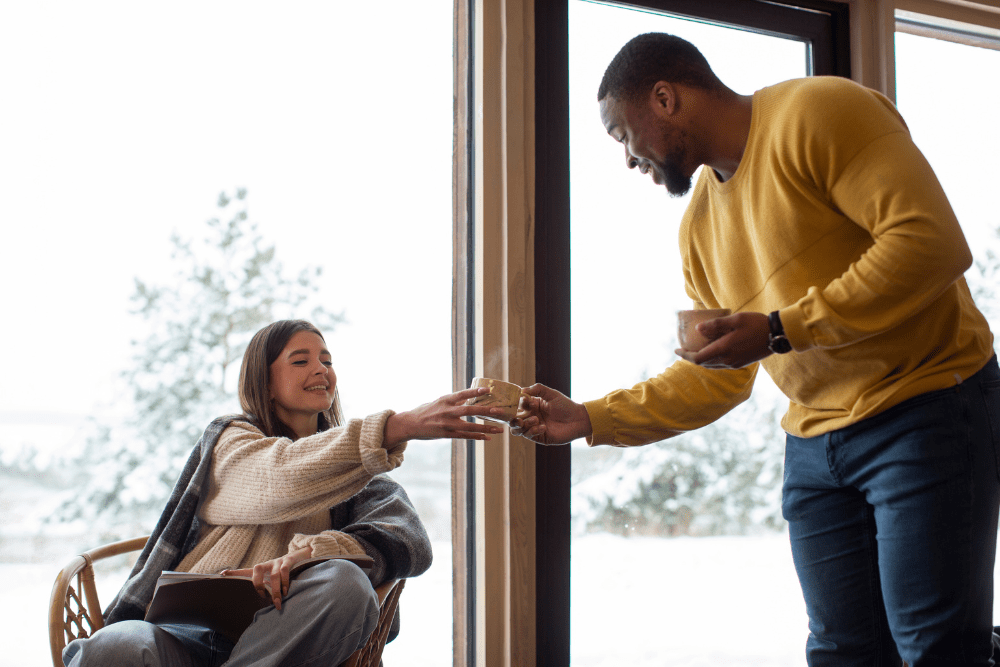 A caring moment as a man offers a cup to a woman, symbolizing compassion and assistance during treatment at a Meth Detox in Nashville facility.