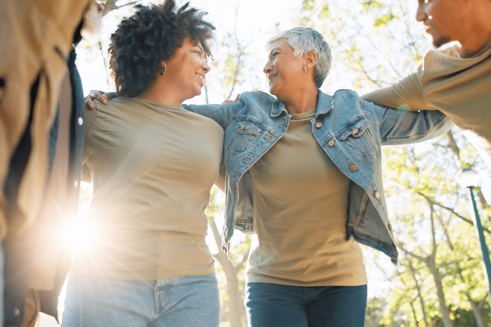 Group of friends supporting each other outdoors, symbolizing the positive impact of Rapid Detox in Nashville on fostering strong connections and recovery.